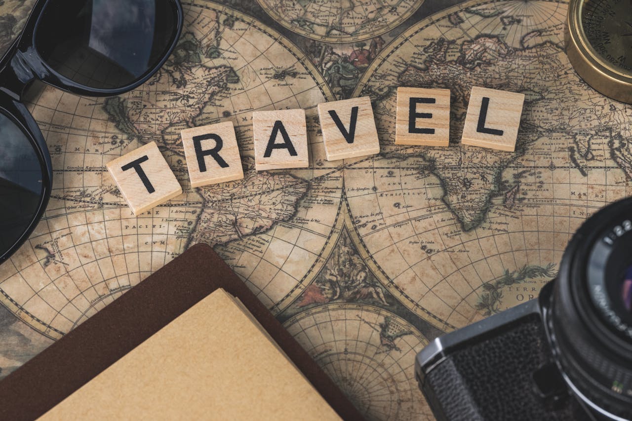 The Art of Drawing Readers In: Your attractive post title goes here Vintage map with travel essentials like camera and sunglasses arranged in a flat lay, perfect for adventure themes.